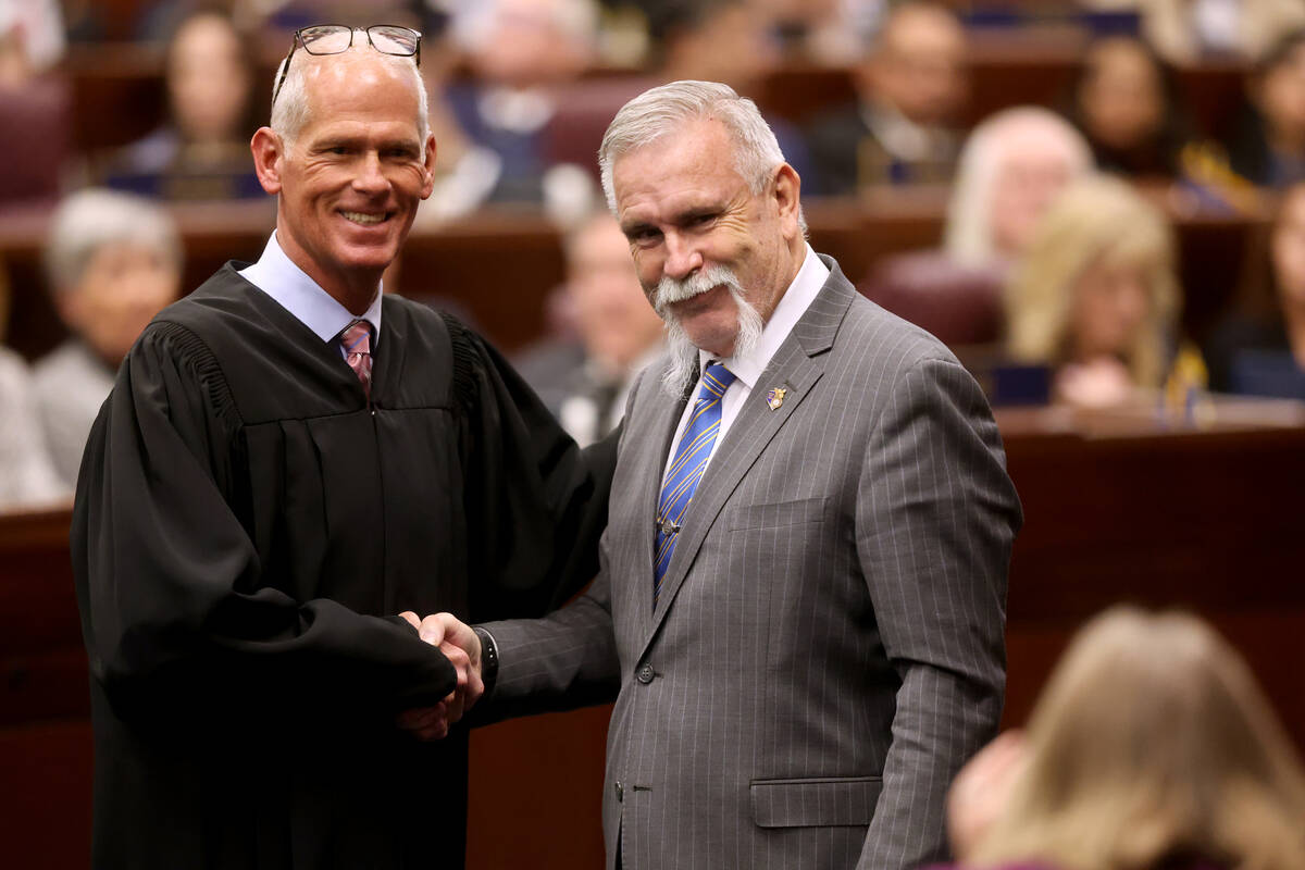 Assembly member Max E. Carter, II, D-Las Vegas, shakes hands with with Chief Justice Douglas He ...