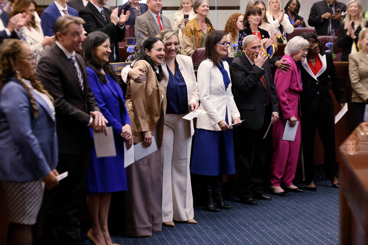 Senators react after being sworn in on the Senate floor in the Legislative Building in Carson C ...