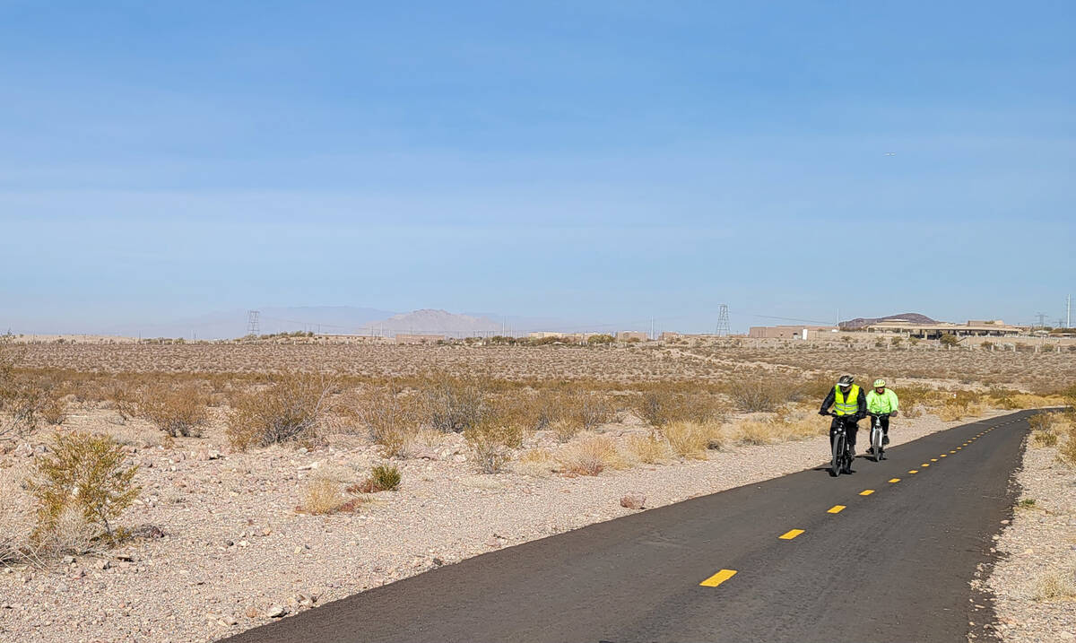 Bicyclists ride toward Boulder City from a Henderson segment of the River Mountains Loop Trail ...