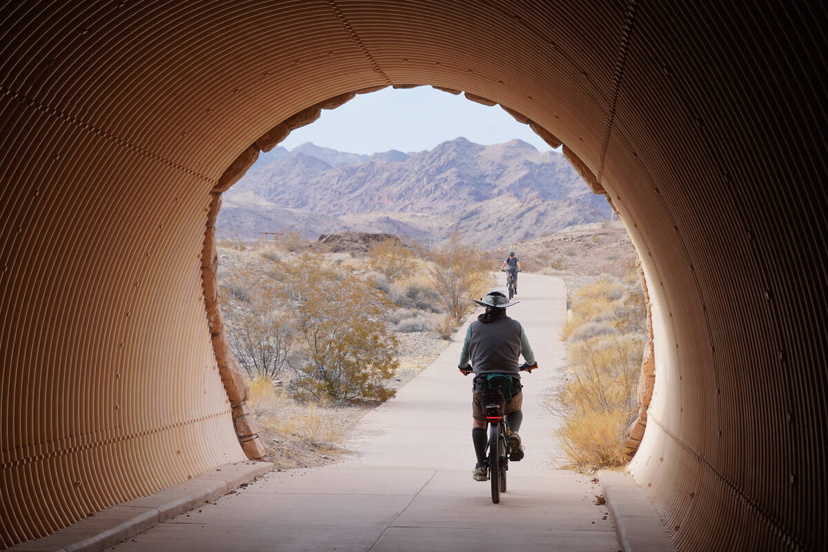 Bicyclists head in and out of a River Mountains Loop Trail tunnel near the Alan Bible Visitor C ...