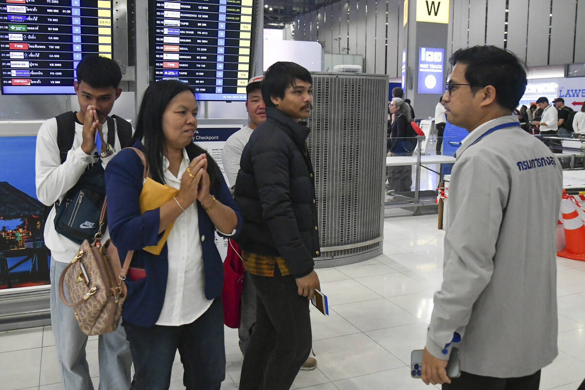 In this photo provided by the Thai Foreign Ministry, an official, right, from the Department of ...