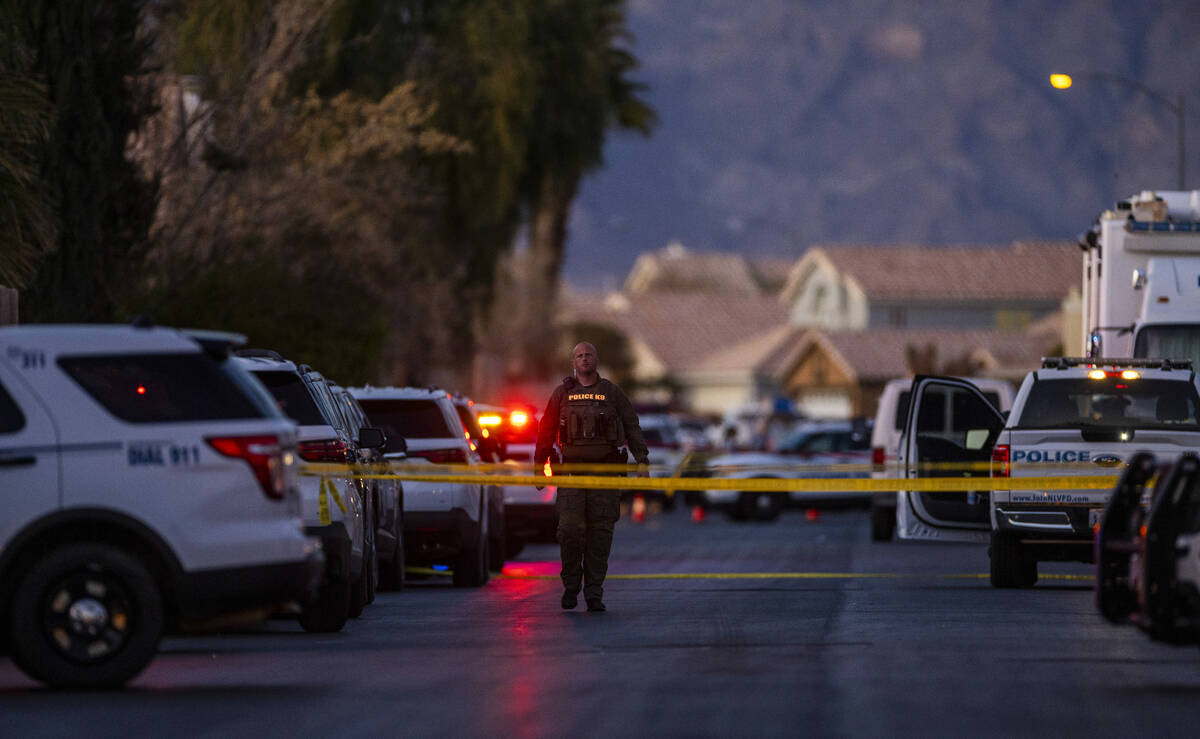 Personnel work the scene of a North Las Vegas Police officer-involved shooting along the 4700 b ...