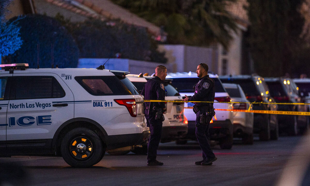 Personnel work the scene of a North Las Vegas Police officer-involved shooting along the 4700 b ...
