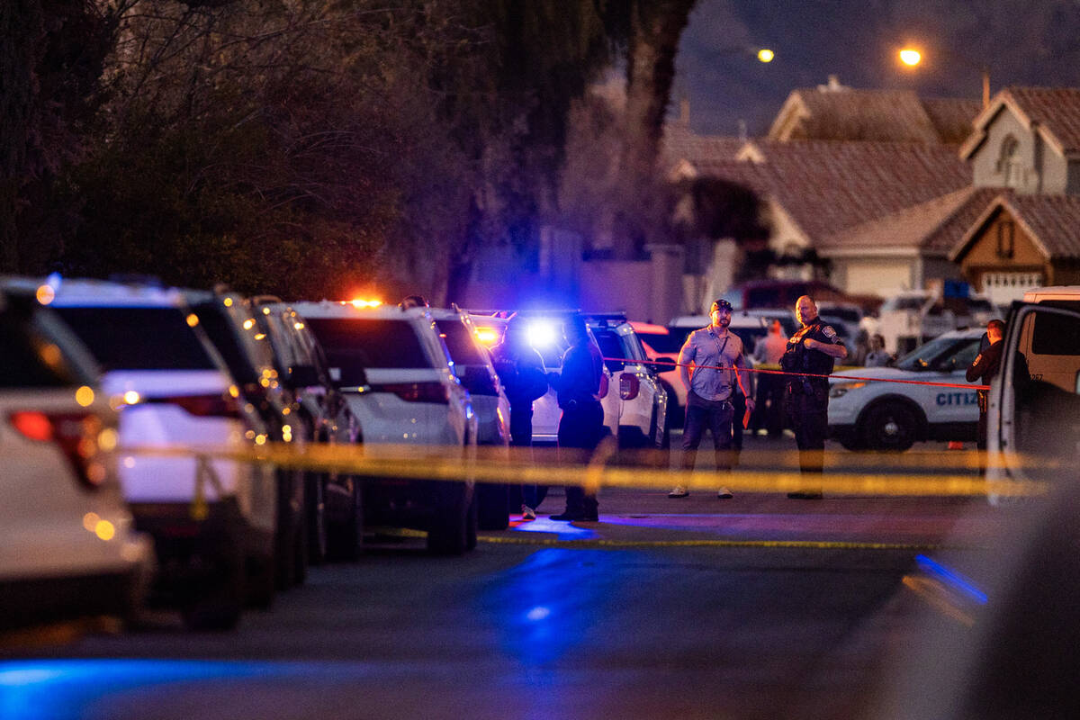 Personnel work the scene of a North Las Vegas Police officer-involved shooting along the 4700 b ...