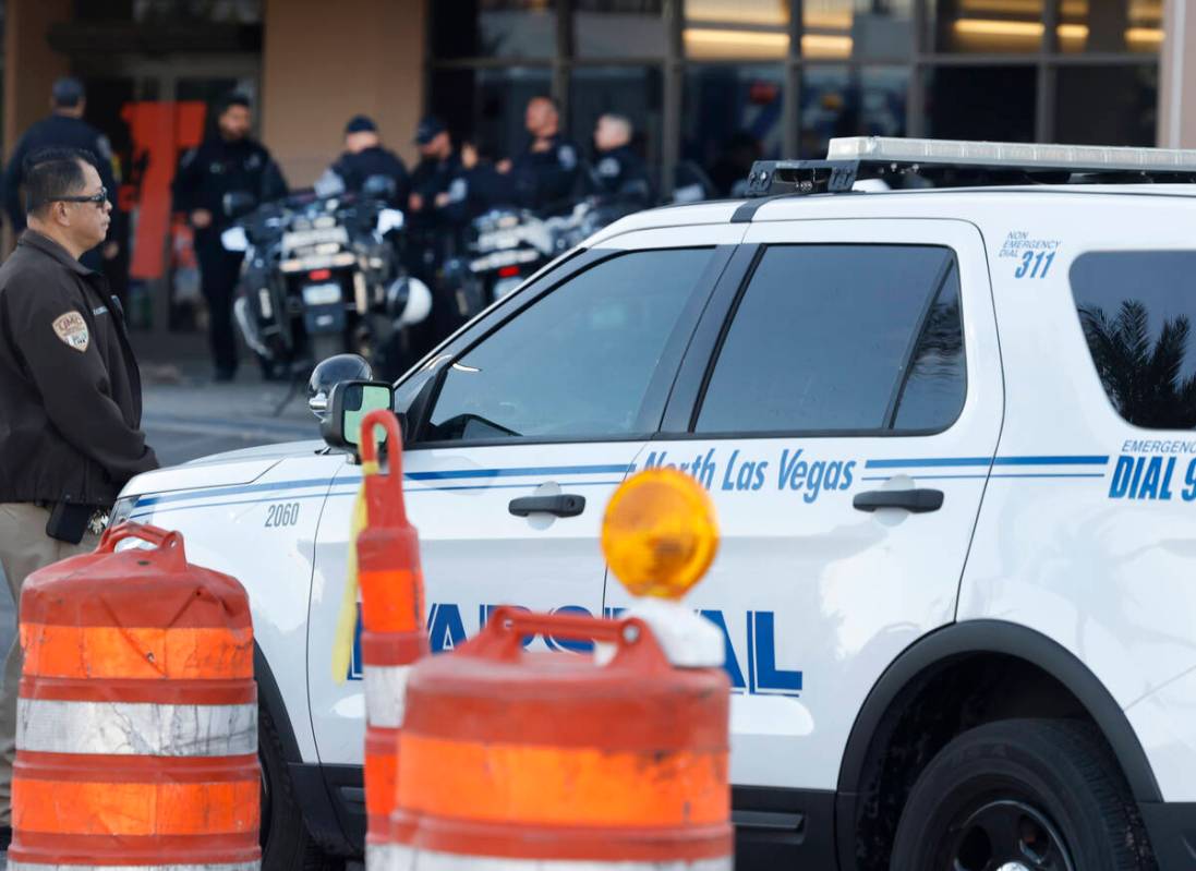Police officers gathered outside of UMC after an officer-involved shooting near Lone Mountain R ...