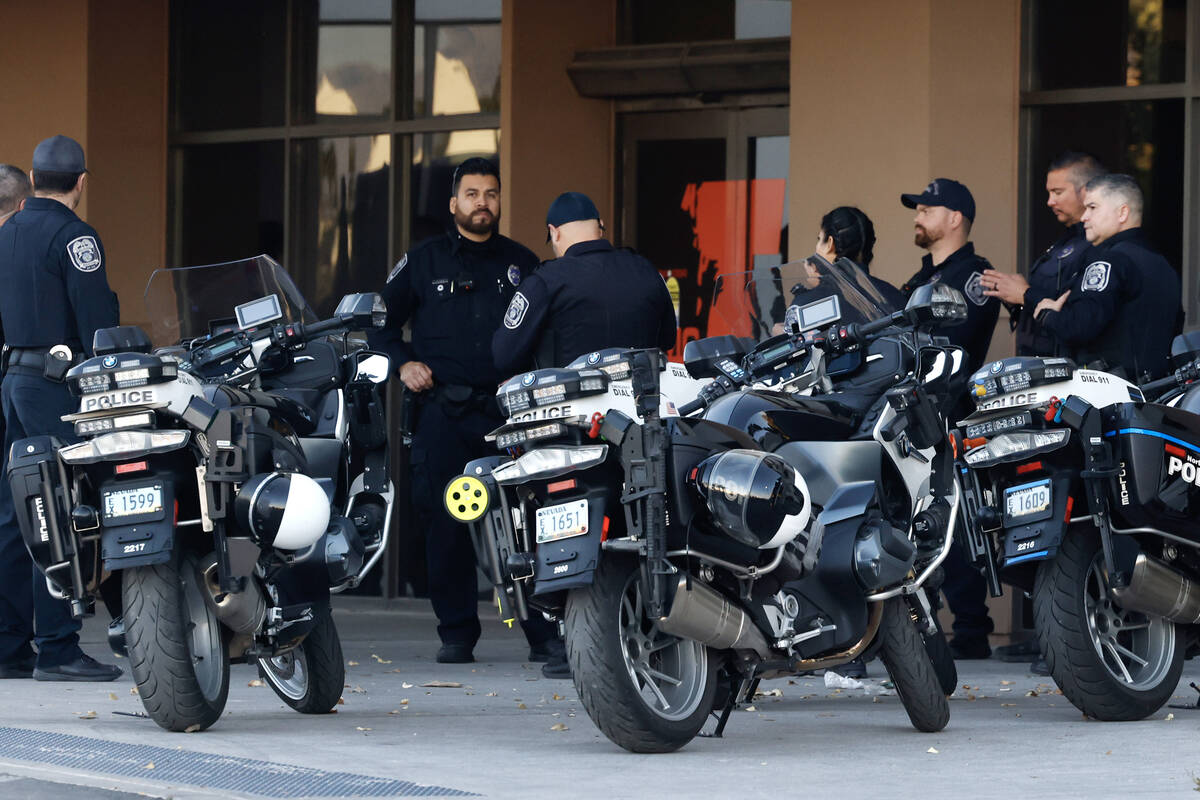 Police officers gathered outside of UMC after an officer-involved shooting near Lone Mountain R ...