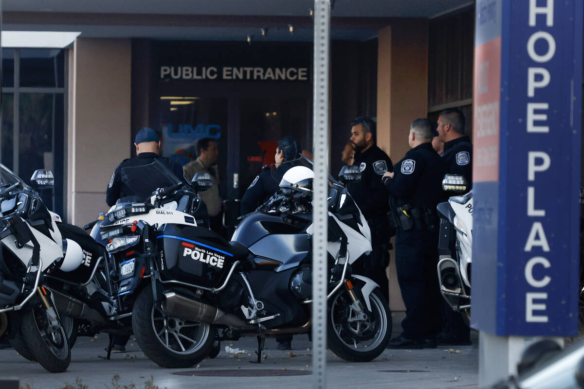 Police officers gathered outside of UMC after an officer-involved shooting near Lone Mountain R ...