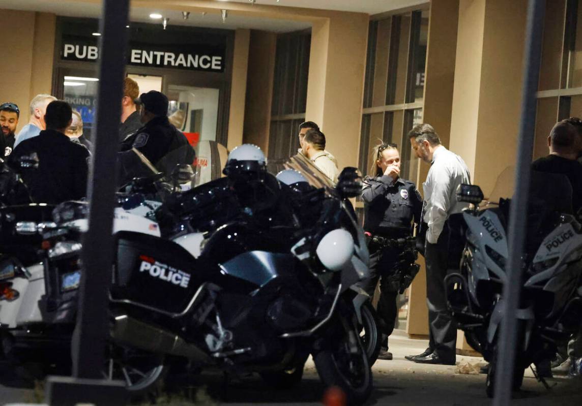 Police officers gathered outside of UMC after an officer-involved shooting near Lone Mountain R ...