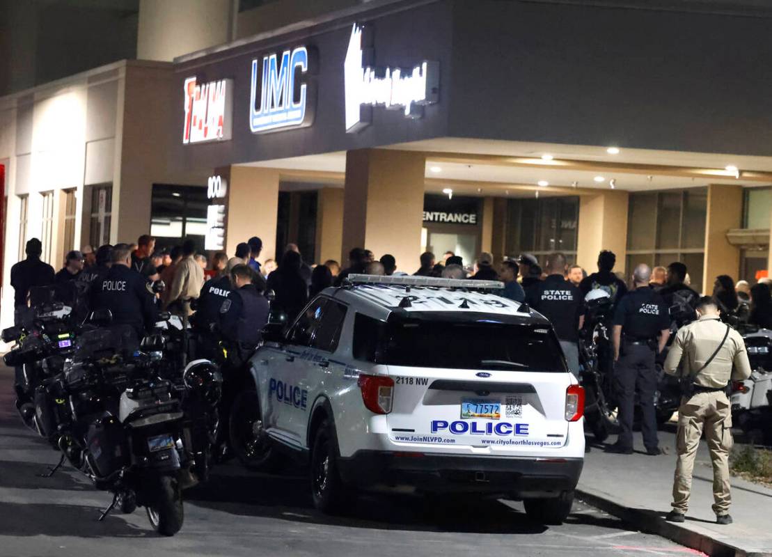 Police officers gather outside of UMC where a North Las Vegas police officer was transported an ...