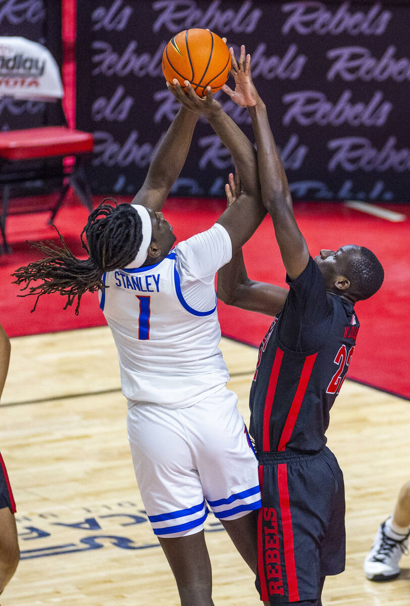 Boise State Broncos forward O'Mar Stanley (1) is blocked by UNLV forward Pape N'Diaye (22) duri ...