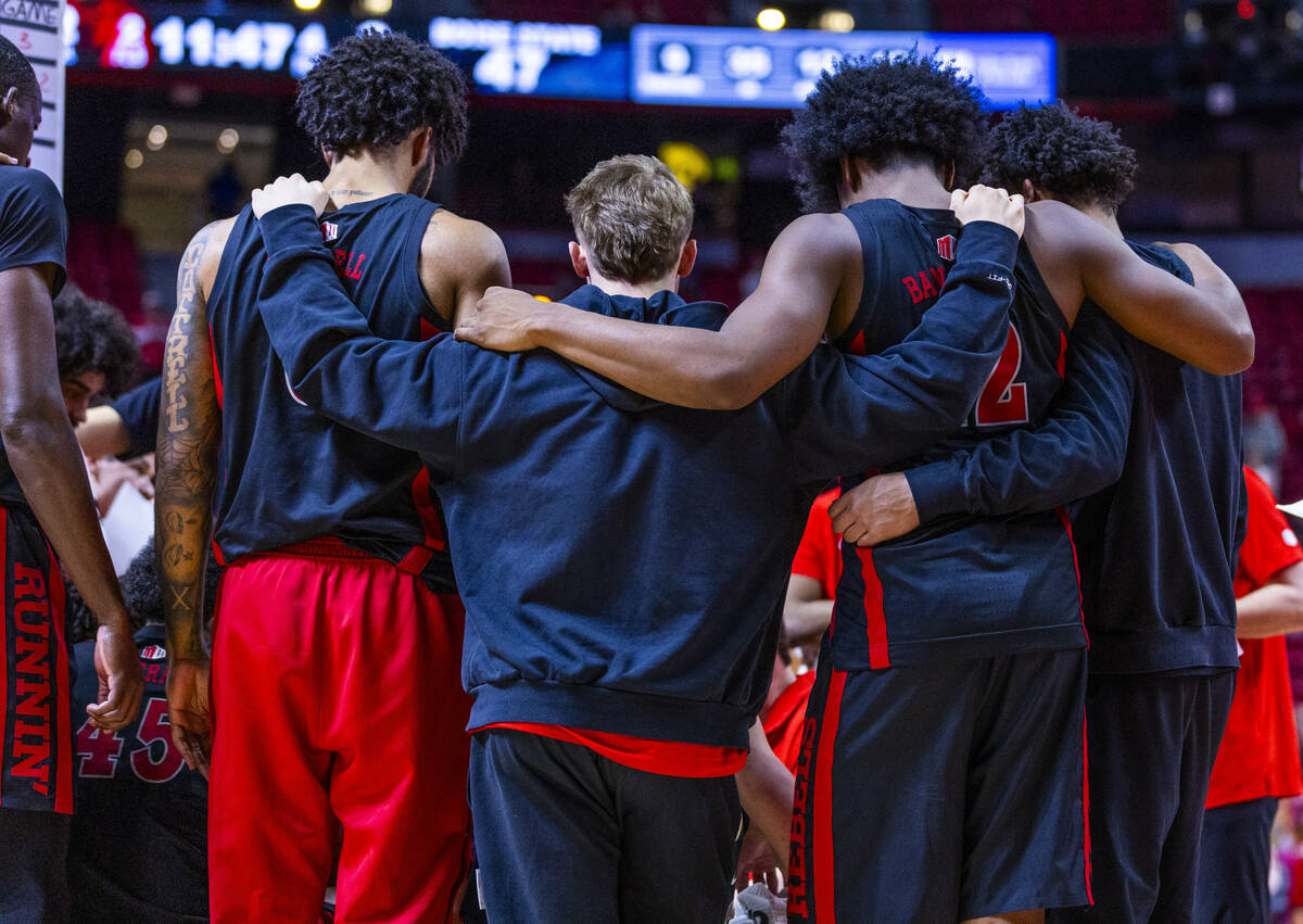 UNLV players come together during a timeout against the Boise State Broncos during the second h ...