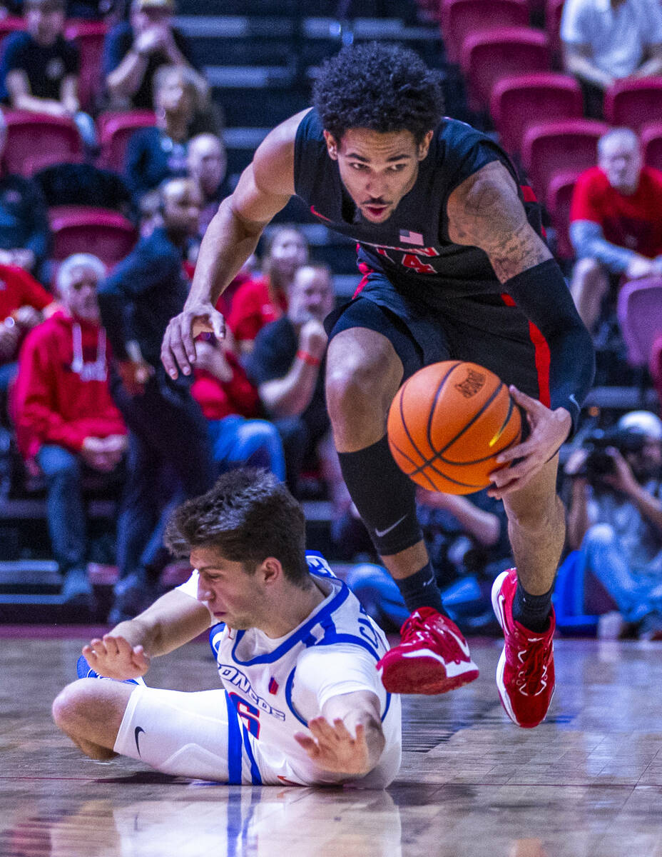 UNLV guard Jailen Bedford (14) steals the ball from Boise State Broncos forward Pearson Carmich ...