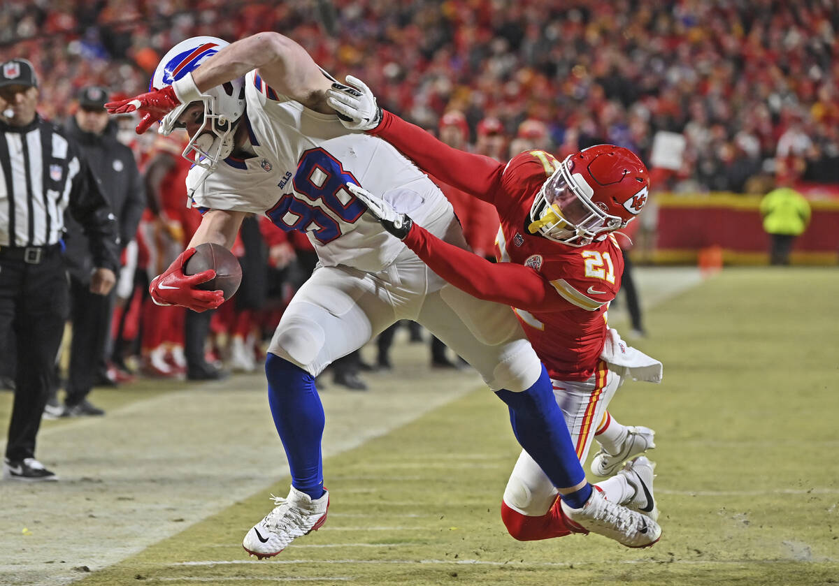 Kansas City Chiefs safety Jaden Hicks (21) pushes Buffalo Bills tight end Dawson Knox (88) out ...
