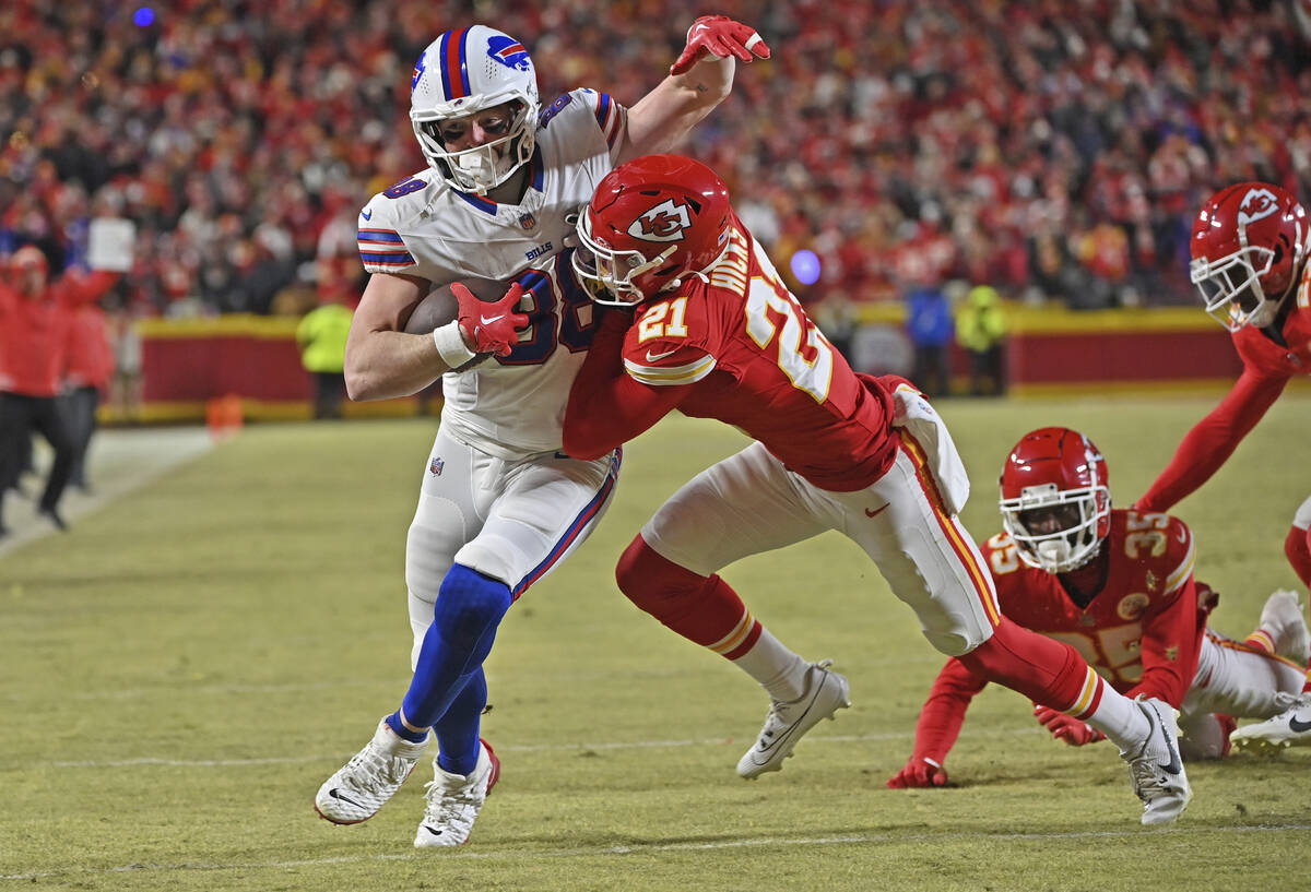 Kansas City Chiefs safety Jaden Hicks (21) pushes Buffalo Bills tight end Dawson Knox (88) duri ...