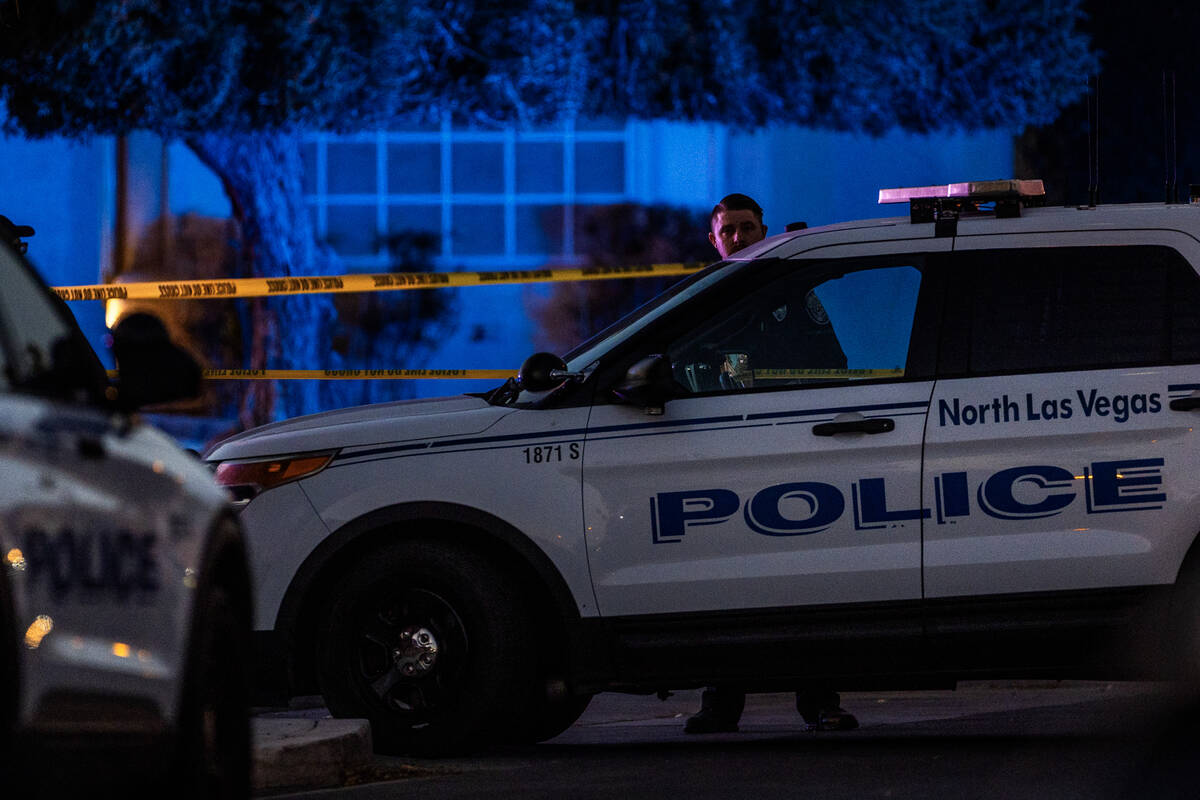 Personnel secure side streets as they work the scene of a North Las Vegas Police officer-involv ...