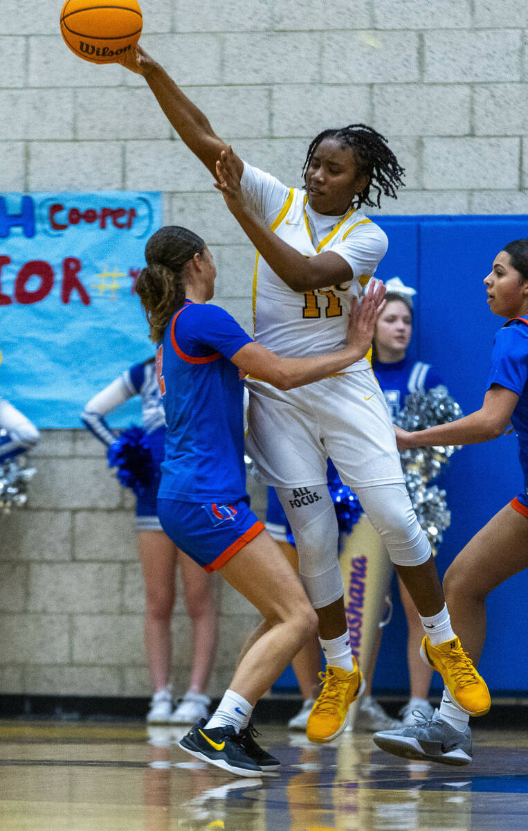 Democracy Prep forward La'Niah Hicks (11) passes the ball over Bishop Gorman guard Addysen Carr ...