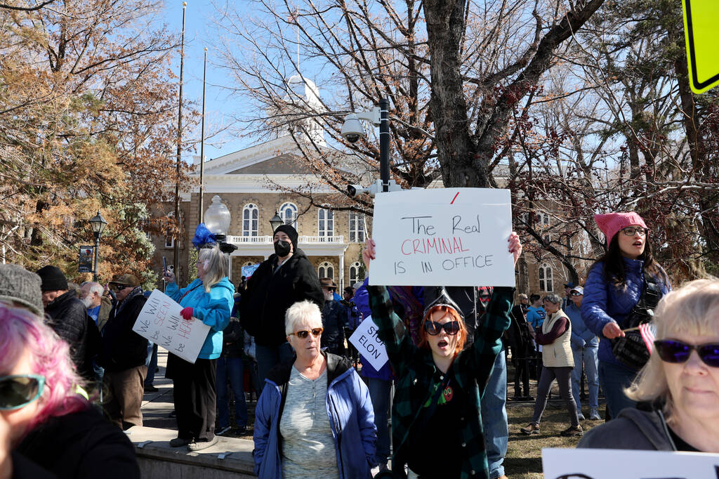 People, including Madison Cordova of Carson City, right, protest the Trump administration at th ...