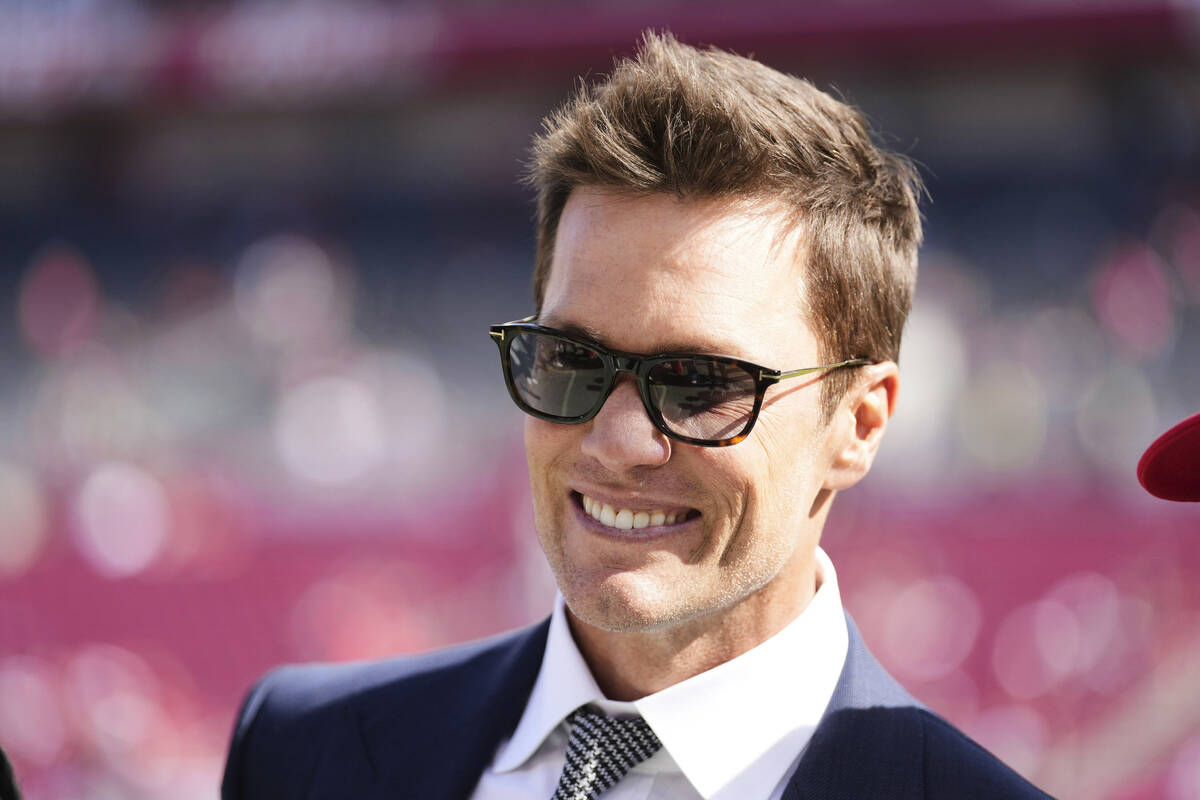 Former NFL quarterback Tom Brady makes an appearance on the field before an NFL football game b ...