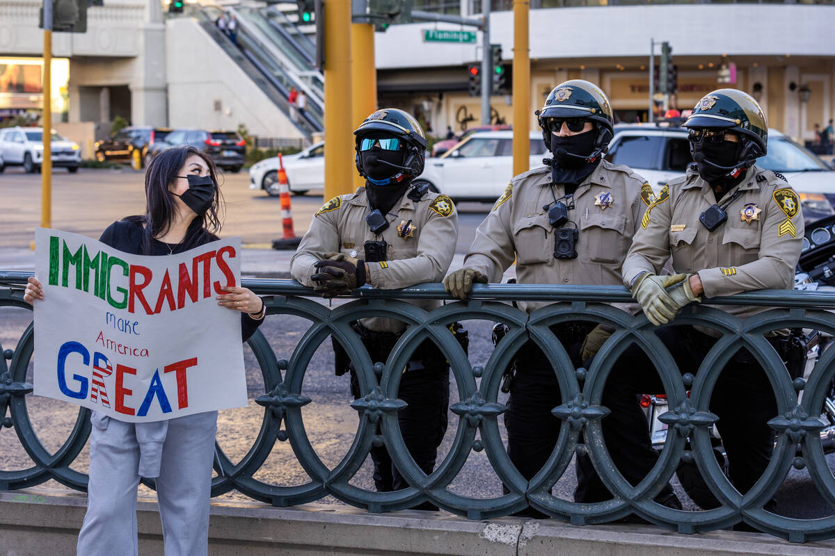 A protester against President Donald Trump's policies talks with Metro officers during a march ...