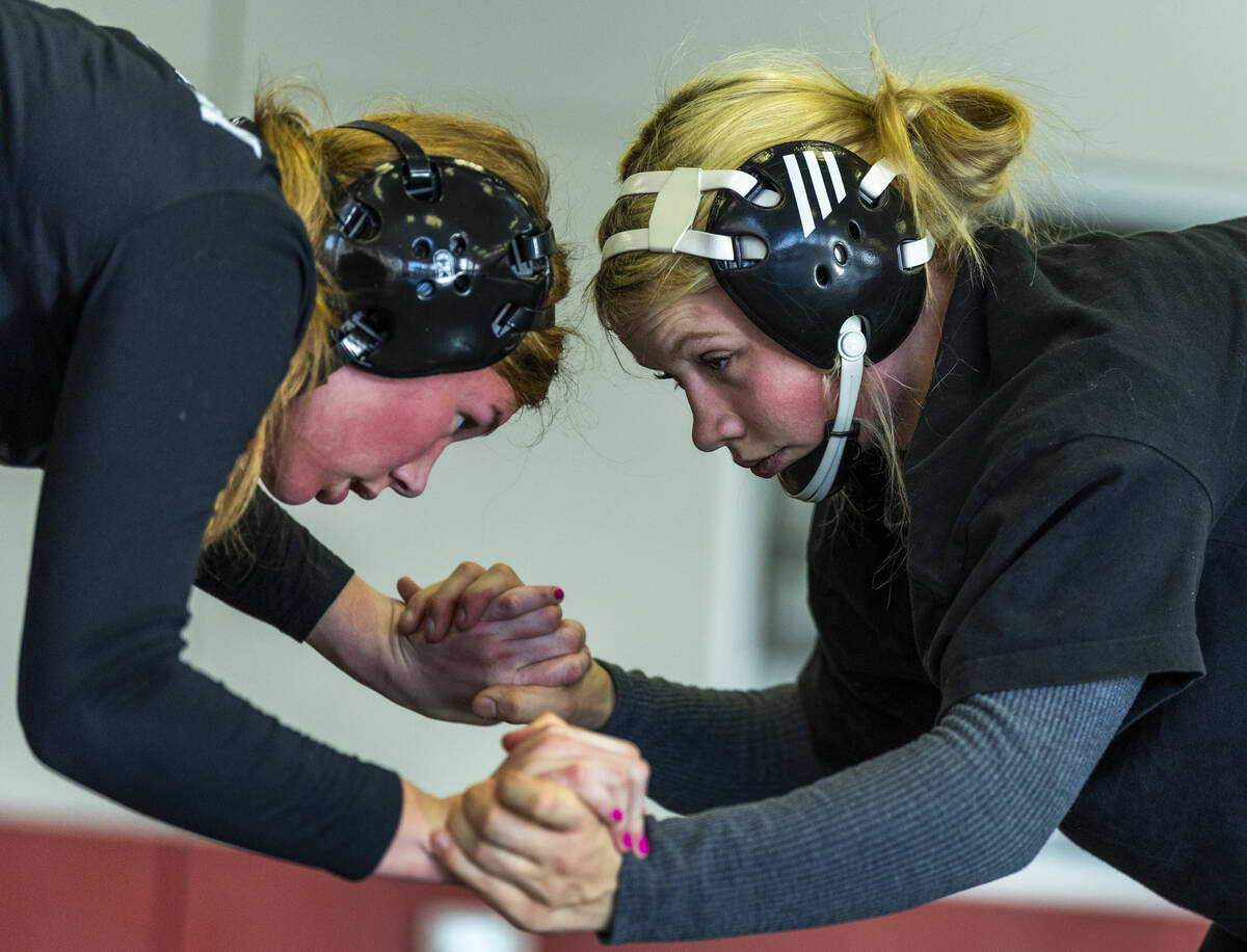 Roni McMillian locks hands with Billie Bonwell during girl's wrestling practice in the cafeteri ...