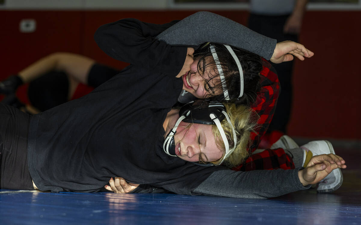 Billie Bonwell works to escape a hold by Mika Yoffee who has the top position during girl's wre ...