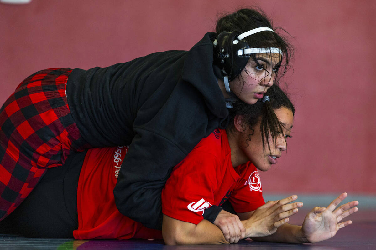 Mika Yoffee has an advantage position atop of Libardi Barcena during girl's wrestling practice ...