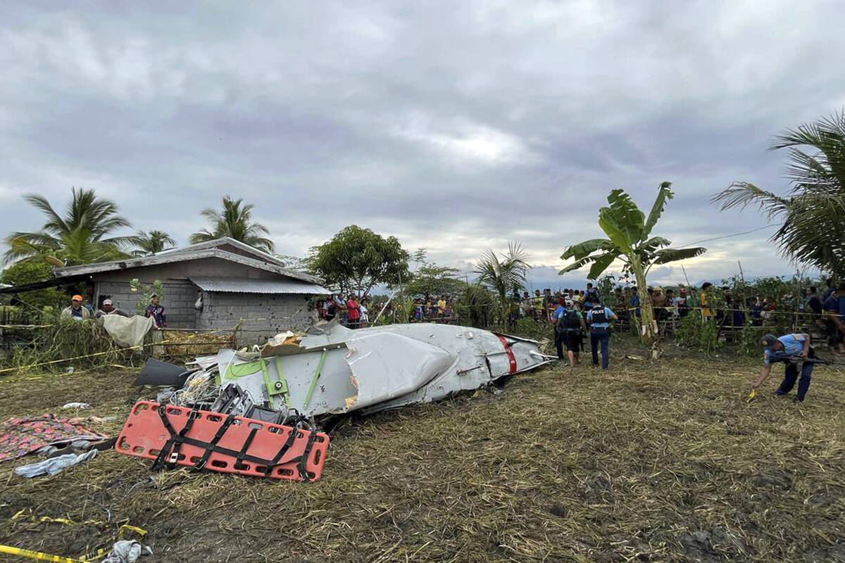 Wreckage of airplane in a rice field in Maguindanao del Sur province, Philippines, after offici ...