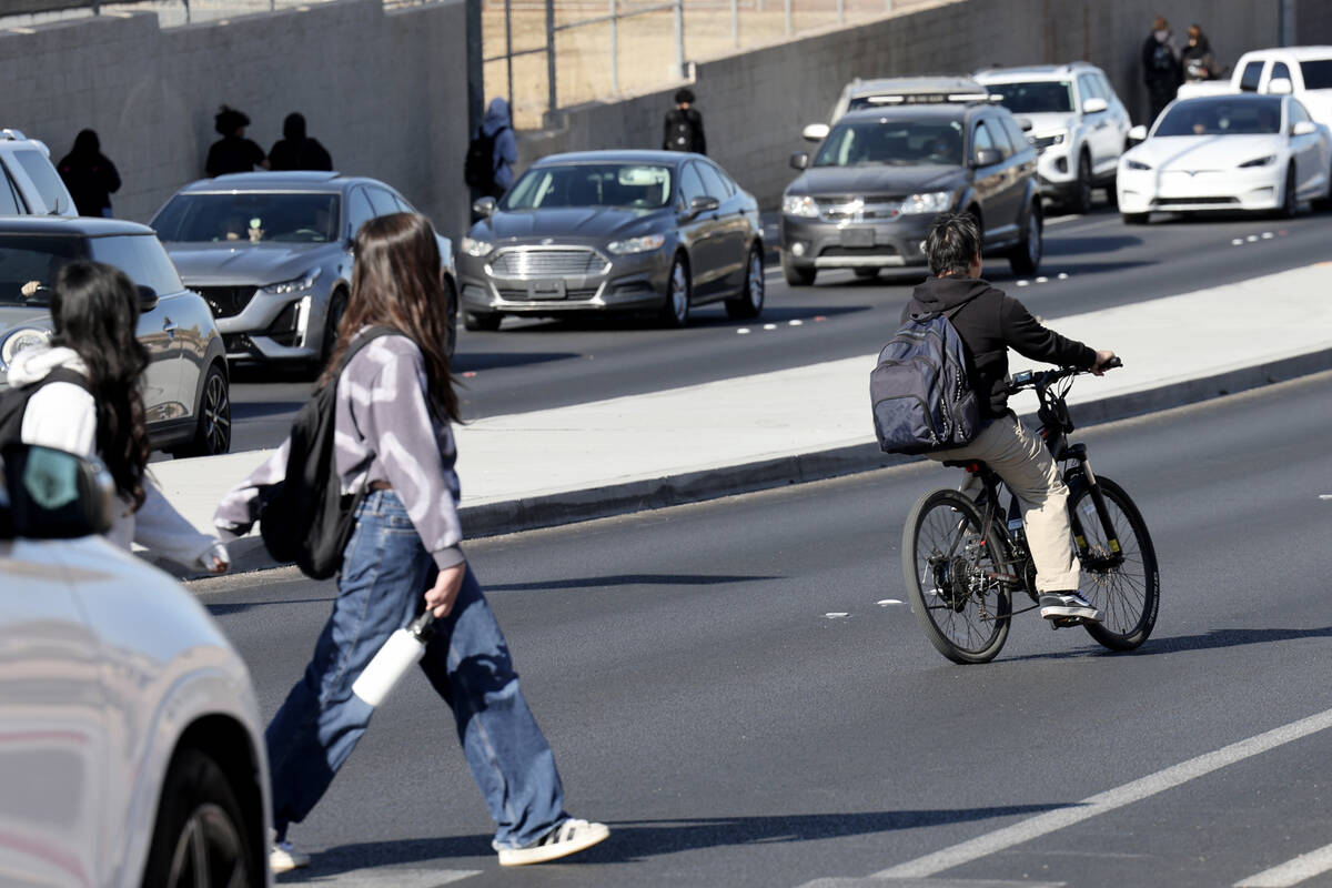 A student rides an e-bike on Coronado Center Drive outside Coronado High School in Henderson We ...