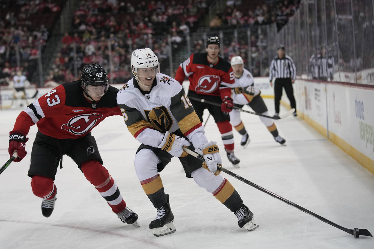 Vegas Golden Knights' Pavel Dorofeyev, right, brings the puck up the ice as New Jersey Devils' ...