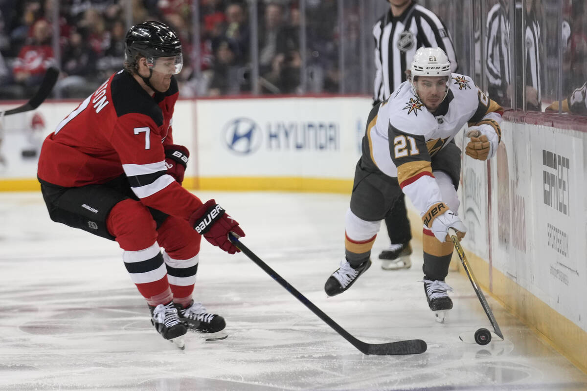 Vegas Golden Knights' Brett Howden, right, brings the puck up the ice while New Jersey Devils' ...