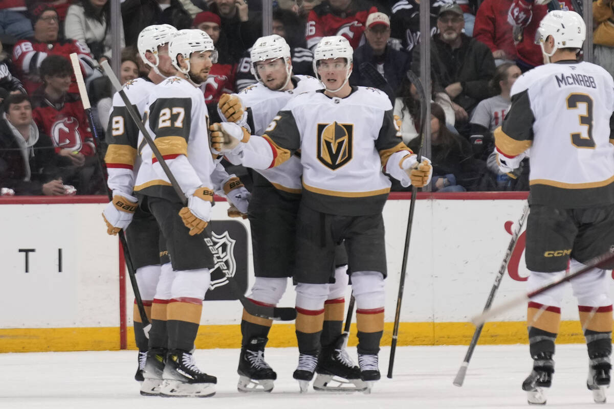 Vegas Golden Knights' Shea Theodore (27), left, celebrates his goal with teammates during the s ...