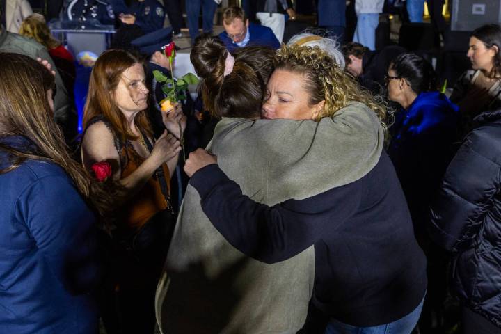 Family members and supporters console each other as the North Las Vegas Police Department, in p ...