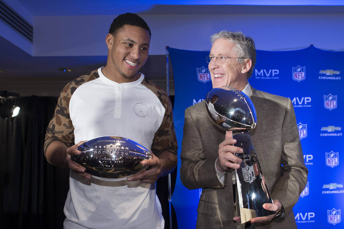 Seattle Seahawks head coach Pete Carroll, right, poses for a photograph with the Vince Lombardi ...