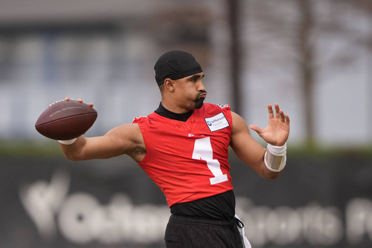 Philadelphia Eagles quarterback Jalen Hurts (1) warms up during an NFL football practice Thursd ...