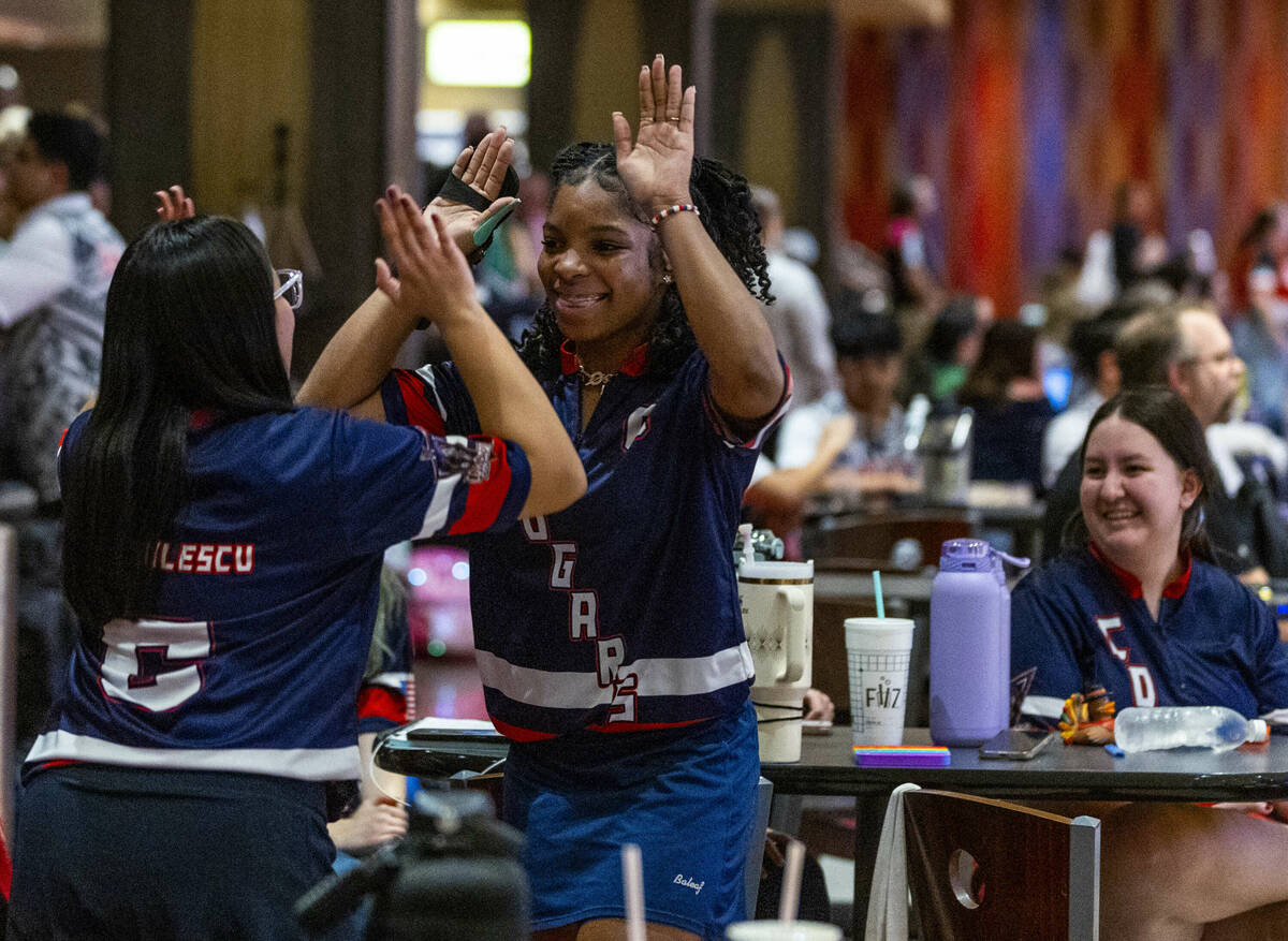 Coronado bowlers Anastasia Dragulescu and Calee Berry slap hands as they take on Clark for thei ...