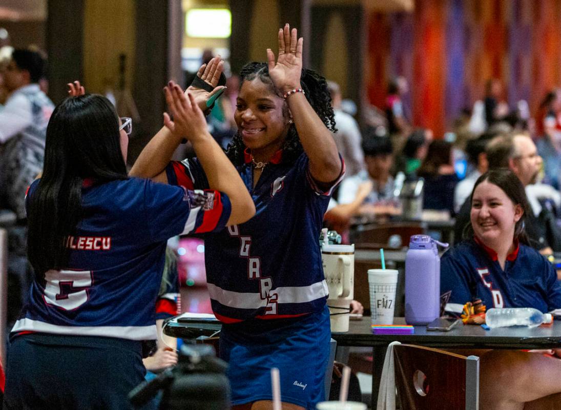 Coronado bowlers Anastasia Dragulescu and Calee Berry slap hands as they take on Clark for thei ...