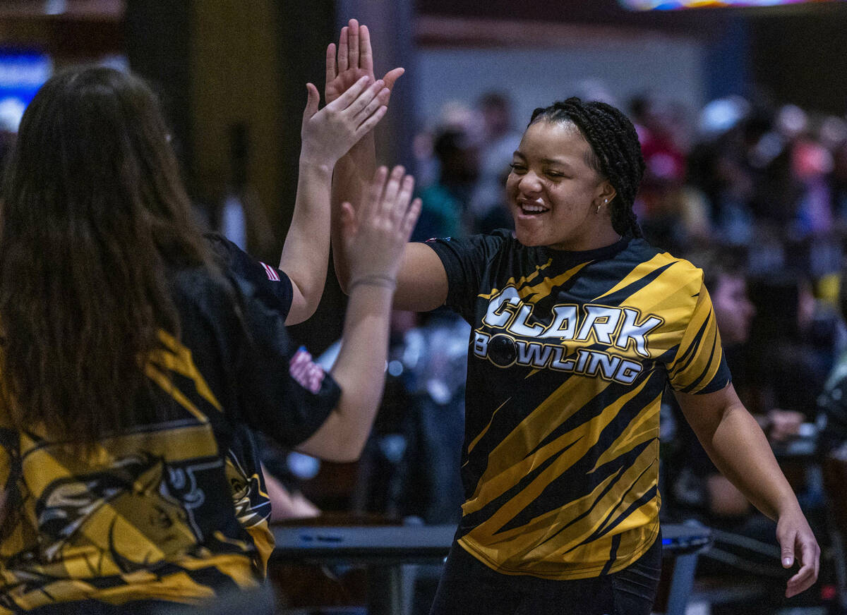 Clark bowler Alliah Jordan gets a high five from a teammate as they take on Coronado during the ...