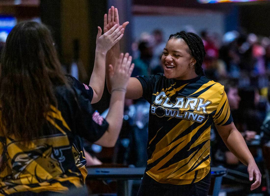 Clark bowler Alliah Jordan gets a high five from a teammate as they take on Coronado during the ...