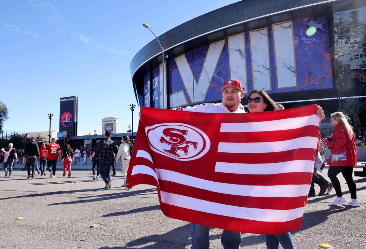 49ers fans Jerry and Leah Torres of Hayward, Calif. celebrate outside Allegiant Stadium in Las ...