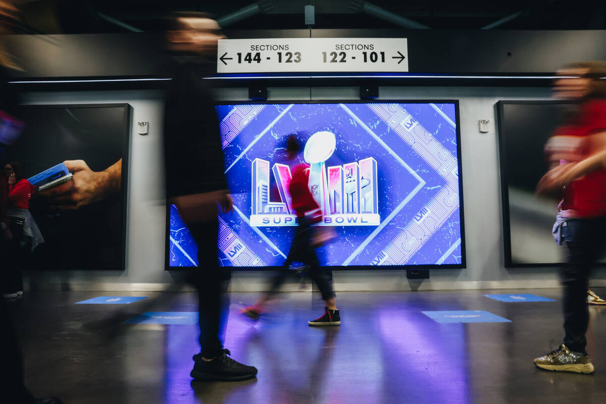 Football fans walk throughout Allegiant Stadium during Super Bowl 58 on Sunday, Feb. 11, 2024, ...