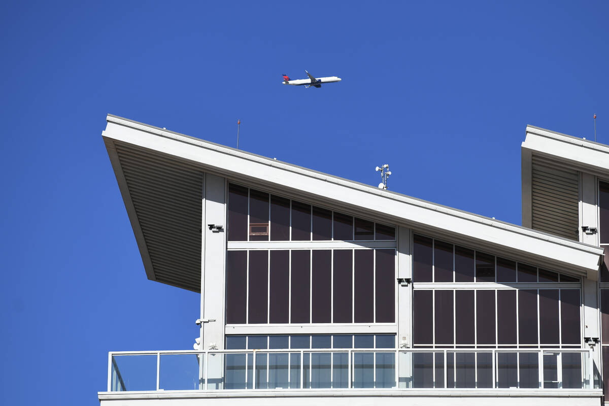 A Delta Air Lines jet flies past the Eastside Cannery on Boulder Highway in Las Vegas Monday, F ...