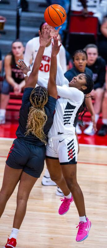 UNLV guard Aaliyah Alexander (25) looks to return a rebound for a basket over New Mexico Lobos ...
