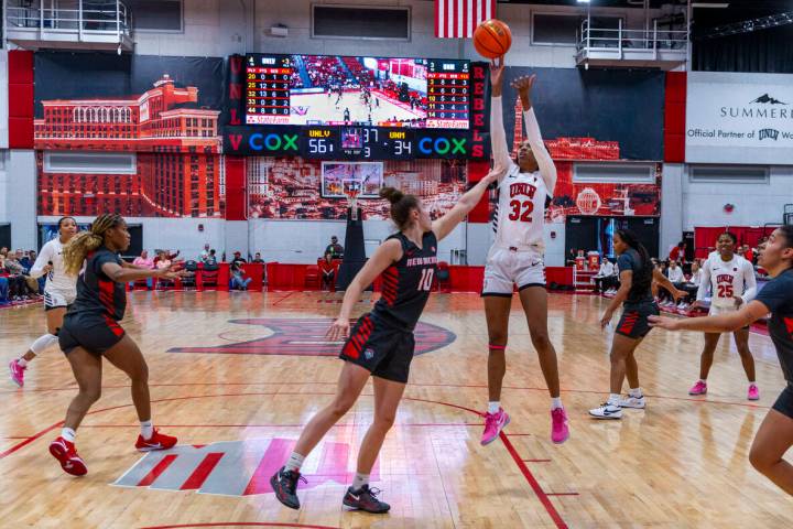 UNLV forward Meadow Roland (32) elevates for a basket over New Mexico Lobos forward Paris Lauro ...