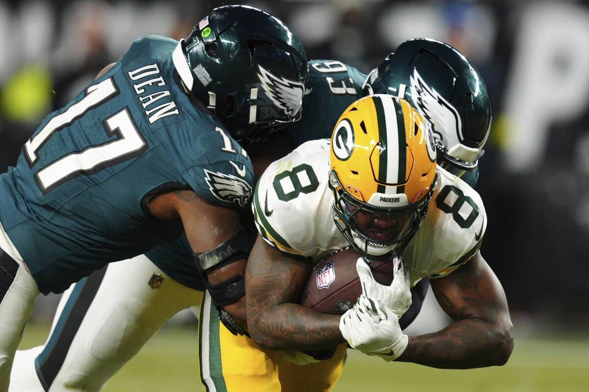 Green Bay Packers running back Josh Jacobs (8) is tackled by Philadelphia Eagles defensive tack ...