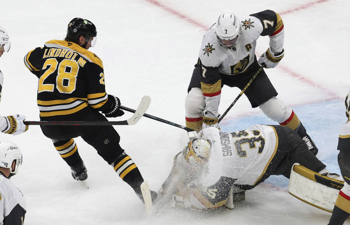 Vegas Golden Knights goaltender Ilya Samsonov (35) grabs the puck in front of Boston Bruins cen ...