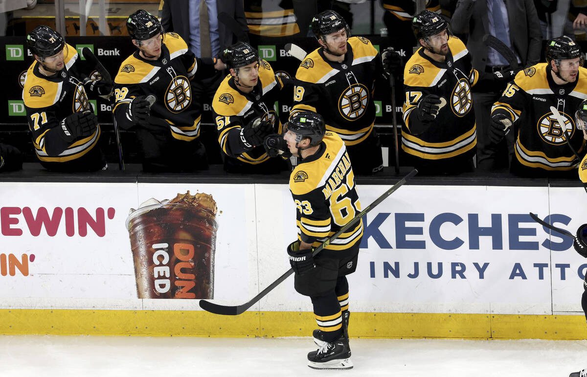 Boston Bruins left wing Brad Marchand (63) celebrates his goal with his team during the first p ...