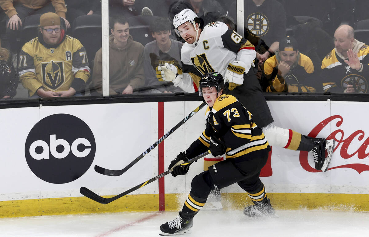 Vegas Golden Knights right wing Mark Stone (61) and Boston Bruins defenseman Charlie McAvoy (73 ...