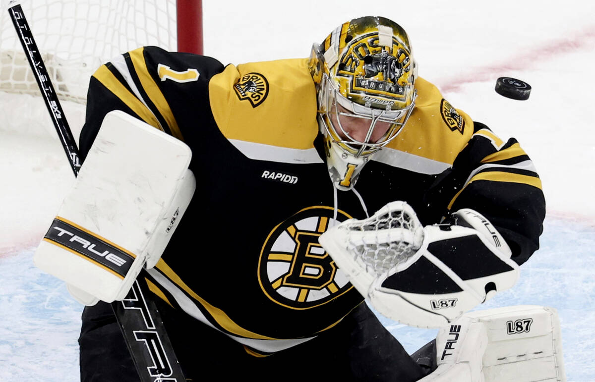 Boston Bruins goaltender Jeremy Swayman (1) deflectst the puck during the first period of an NH ...