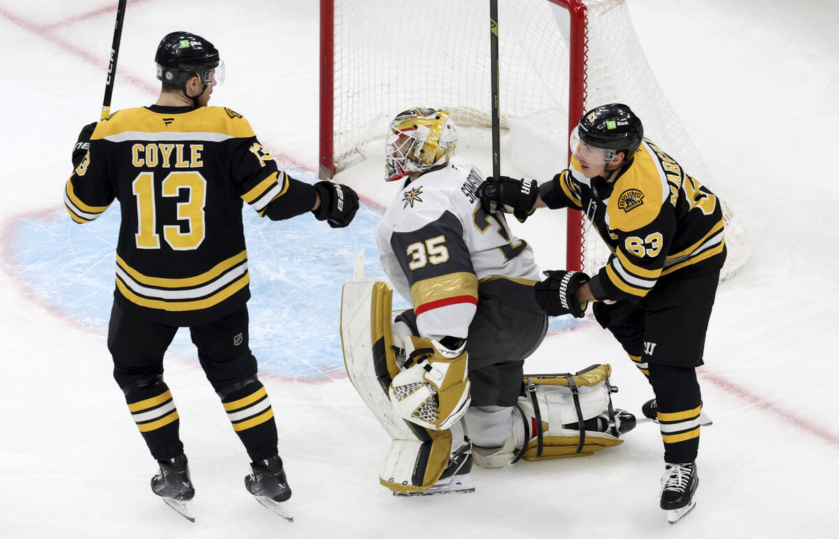 Boston Bruins center Charlie Coyle (13) and Boston Bruins left wing Brad Marchand (63) react af ...