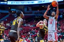 UNLV guard Jaden Henley (10) gets inside of Wyoming Cowboys forward Matija Belic (7) for a bask ...